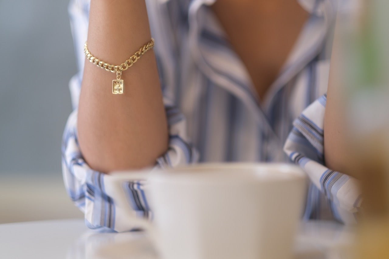 Cross Bracelet - IN A PEACE - gold -next to coffee cup