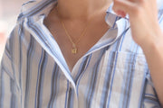 Cross Necklace - IN A PEACE with a blue shirt